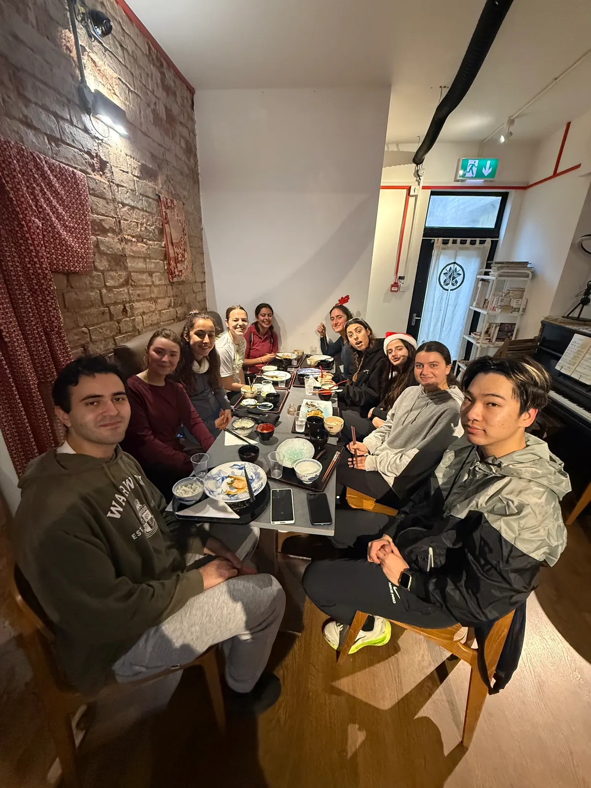 A long table of people eating together after the run