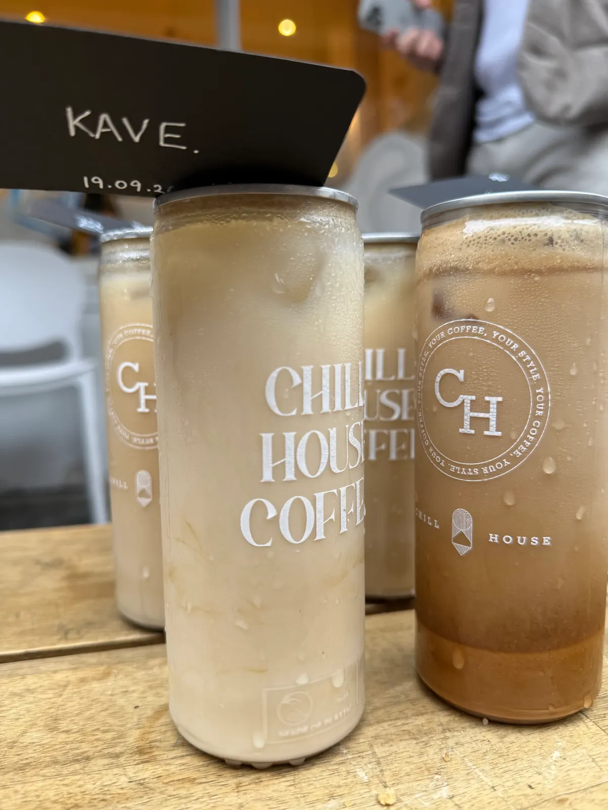 A can of iced coffee with a card on it reading KAVE and the date