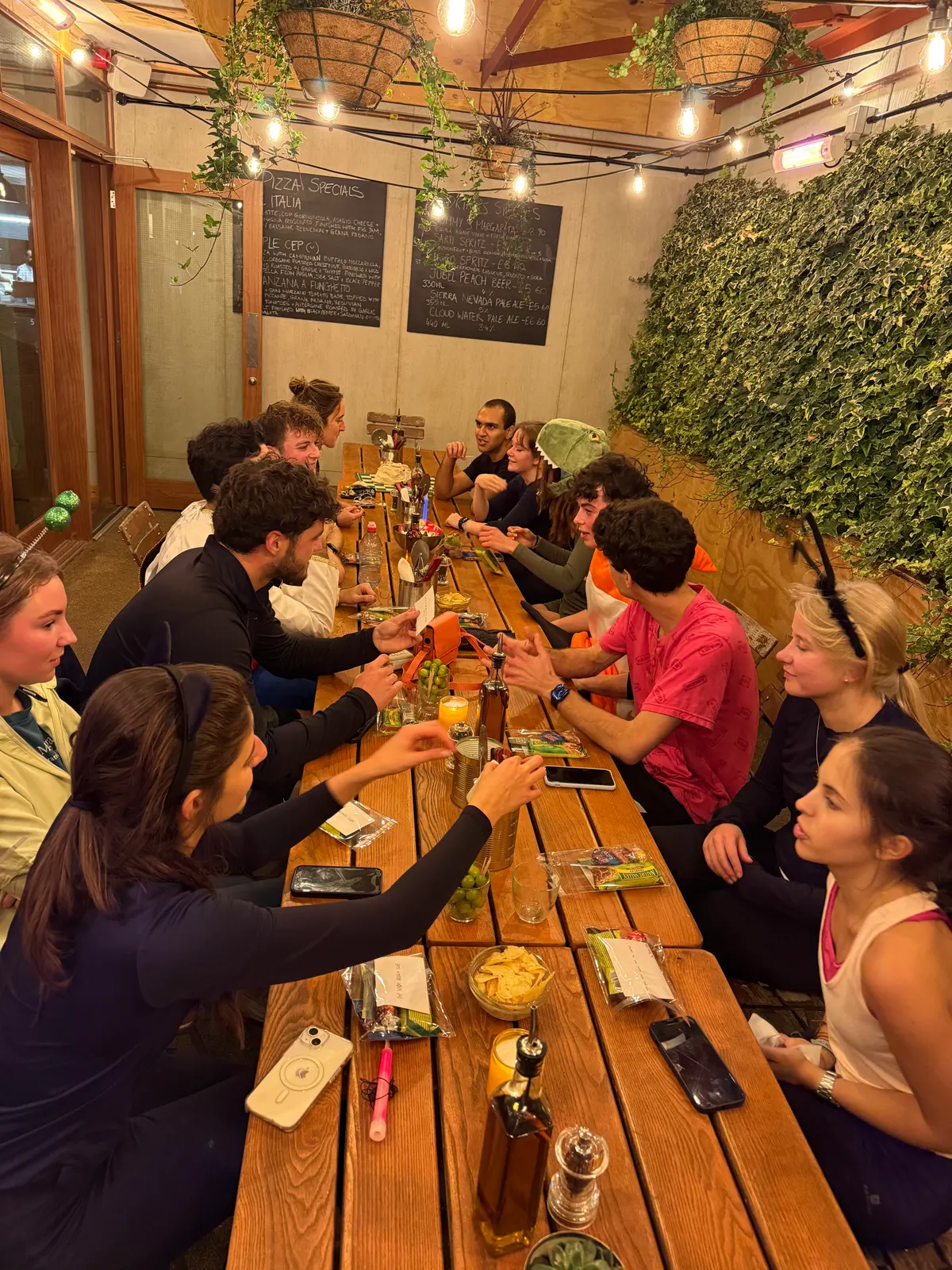 The same long table from the other end, people reaching across it